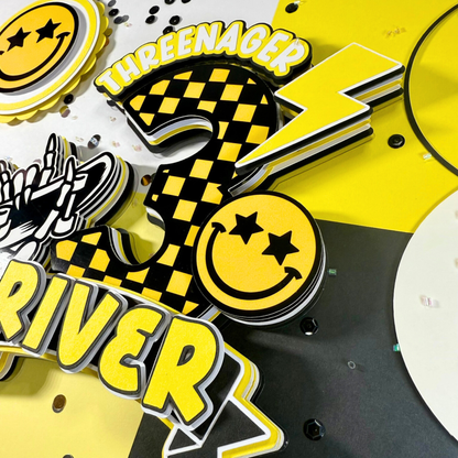 Yellow and black decorative elements with text and smiley faces on a dark background