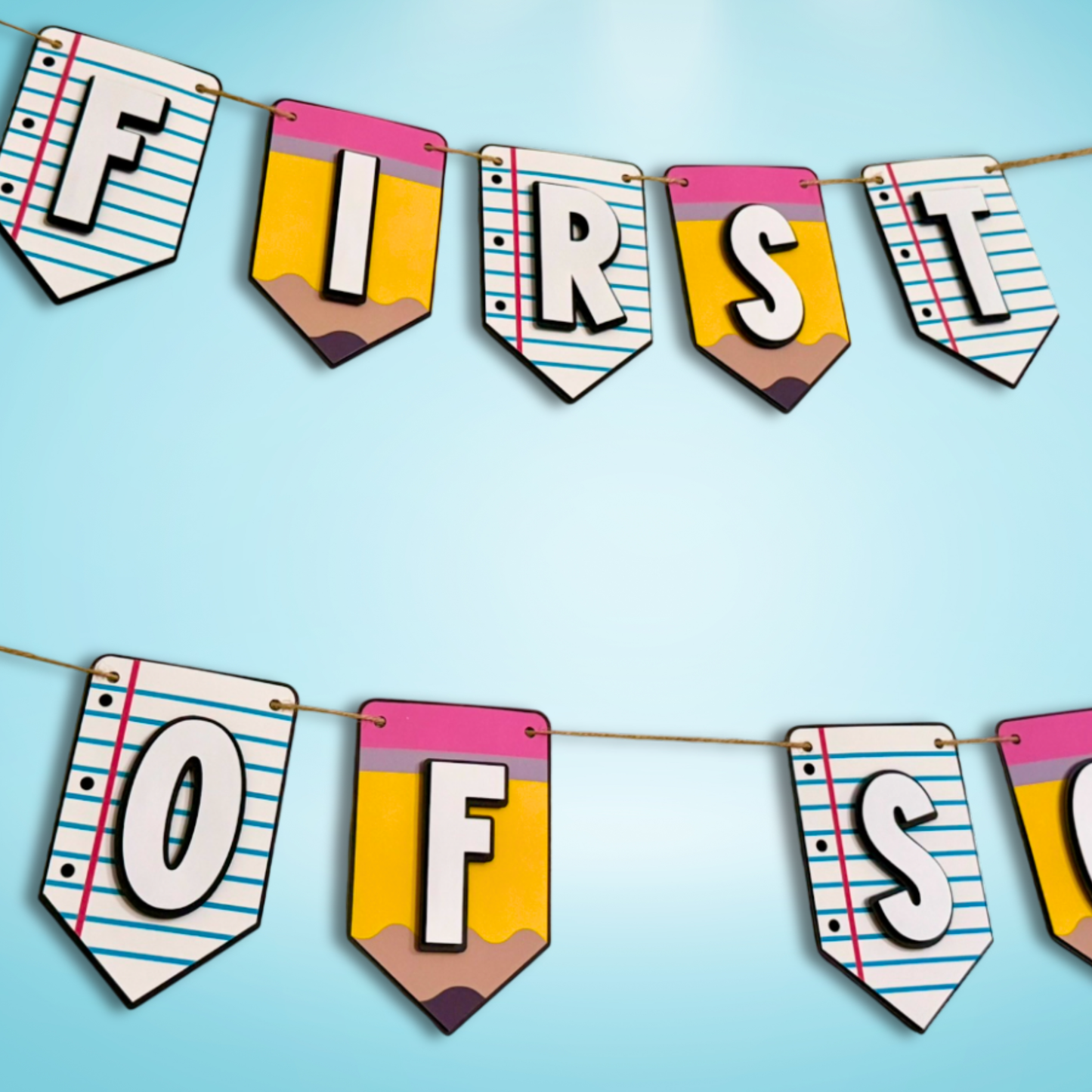 Colorful paper banner with pencil designs spelling 'First of' on a blue background