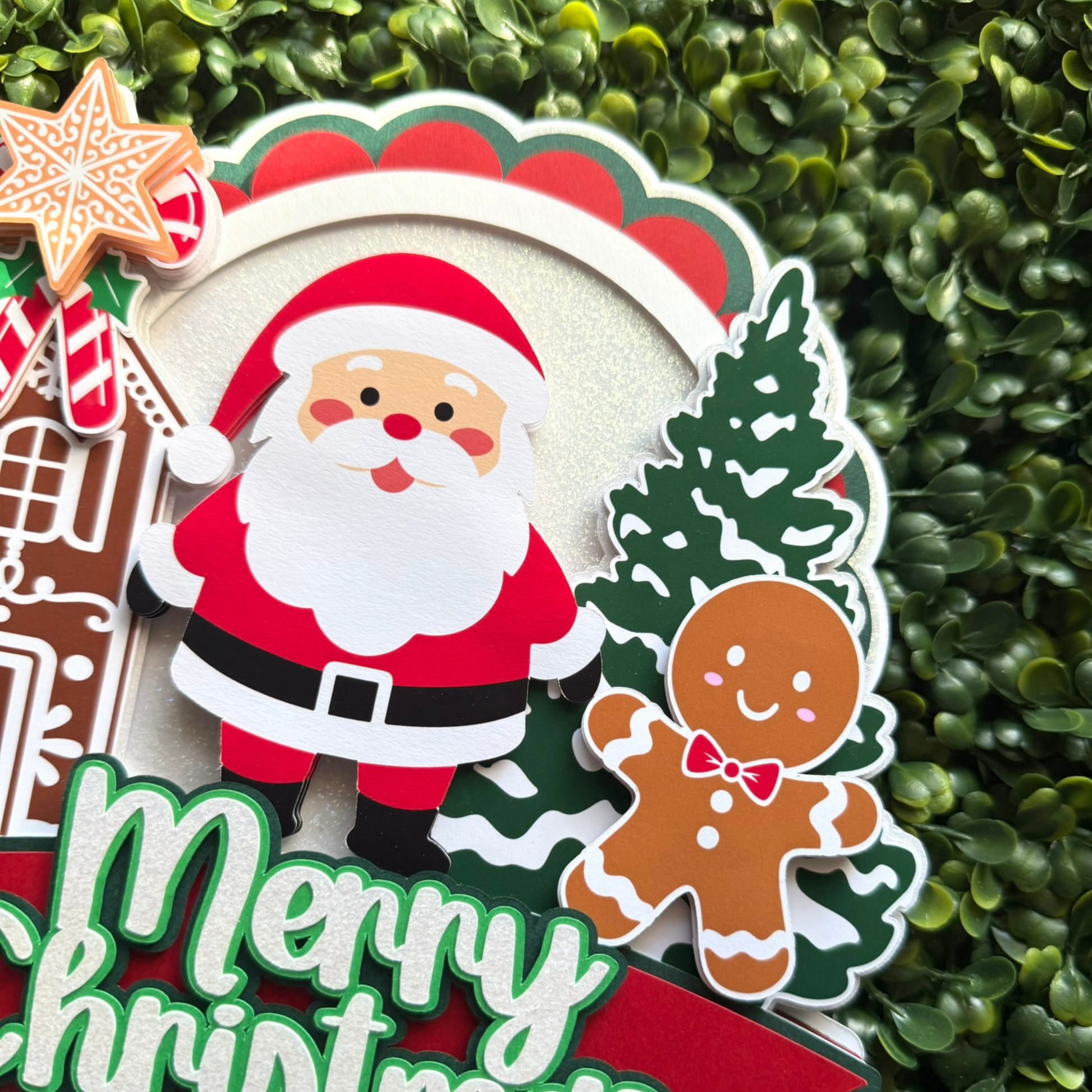 Decorative Christmas sticker with Santa Claus, gingerbread man, and tree on a green leaf background