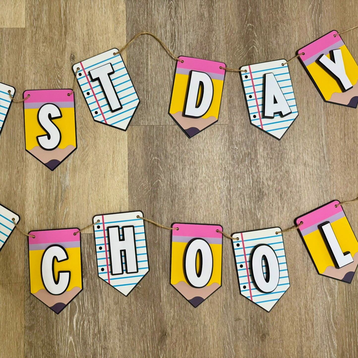 Colorful 'School' banner made of paper cutouts on a wooden surface