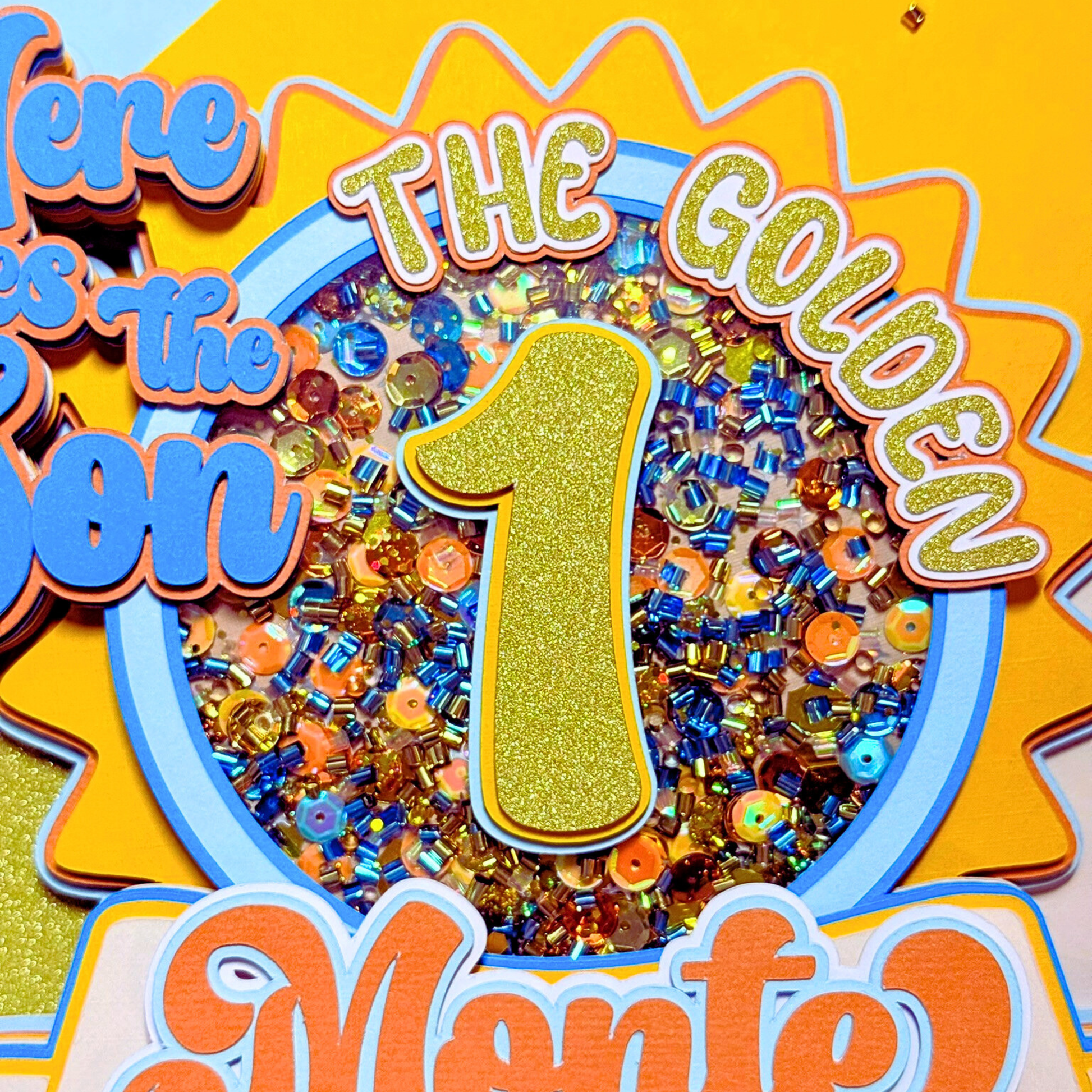 Decorative sign with colorful beads, number 1, and text on a yellow background