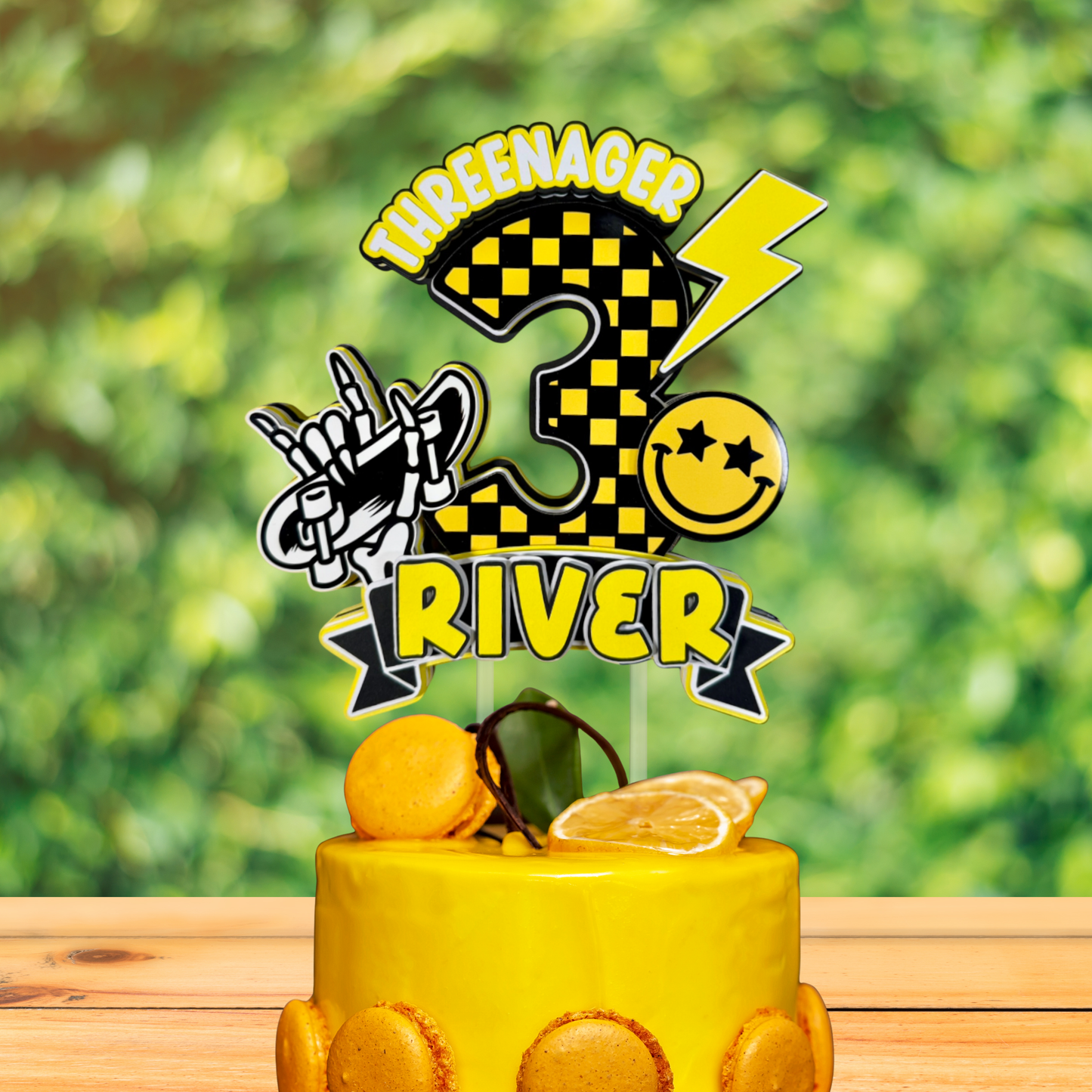 Yellow cake with a birthday cake topper featuring the number 3 and personalized text against a blurred green background.