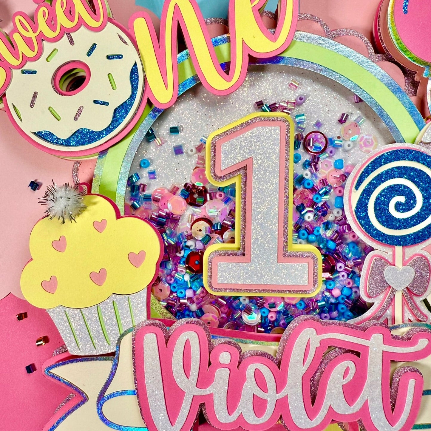 Colorful birthday decoration with 'sweet one' and number '1' for a first birthday party, featuring the name 'Violet'.